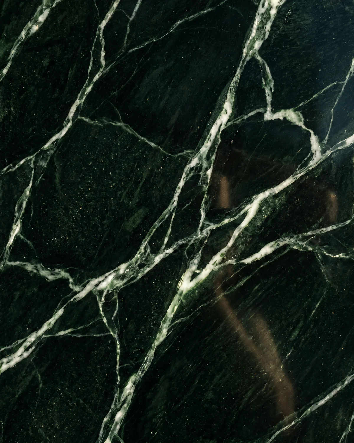 Deep green marble slab with white jade veining